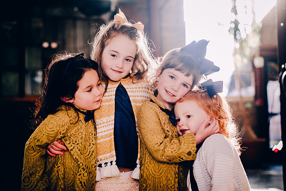 Four little girls who are cousins hugging at Factory at Franklin portrait session