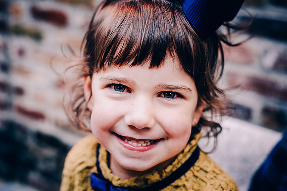 Photo of a little girl sitting on a bench at the Factory at Franklin