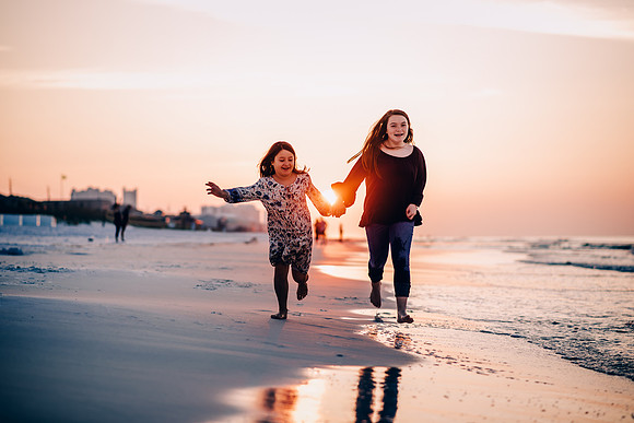 Two Sisters Running On The Beach