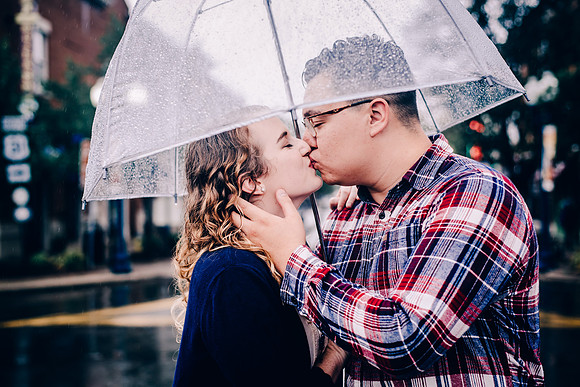 Couple Kissing In The Rain Under An Umbrella In Downtown Franklin, TN