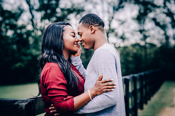 Beautiful Couple About To Kiss At Thompson Station Park Engagement Portrait Session